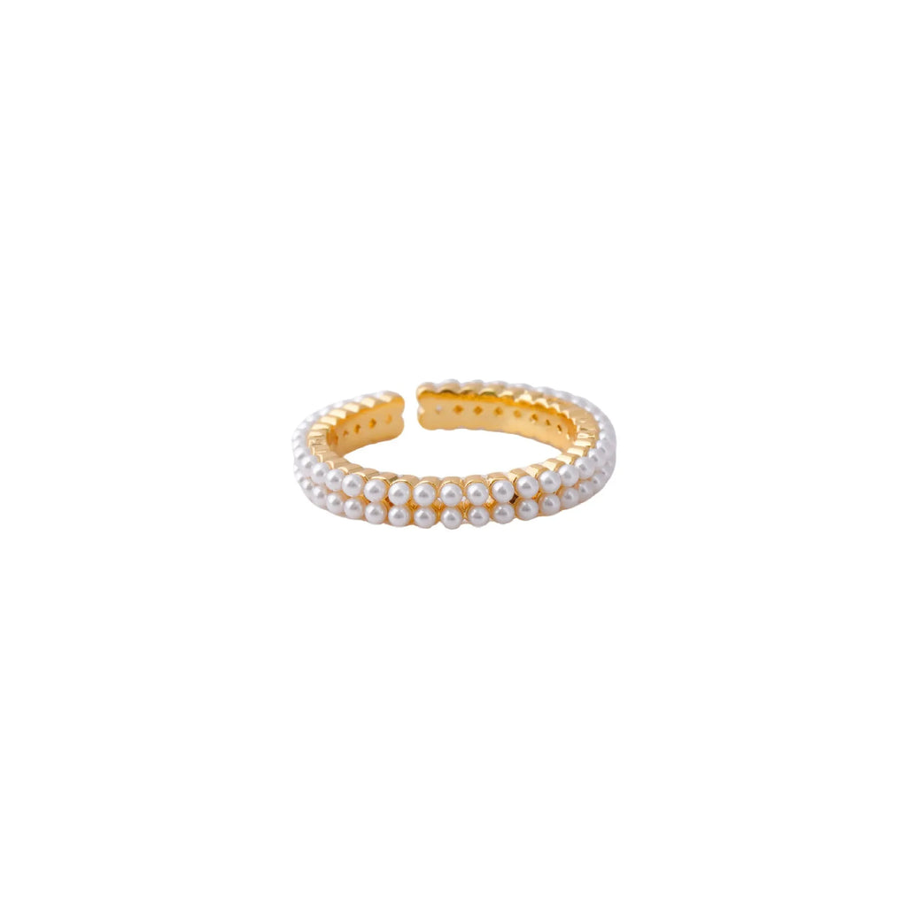 Gold coloured open mouth ring with geometry modelling and round design elements on copper base