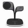 Black 3-in-1 wireless charging station holding a phone, smartwatch, and headphones on a desk.