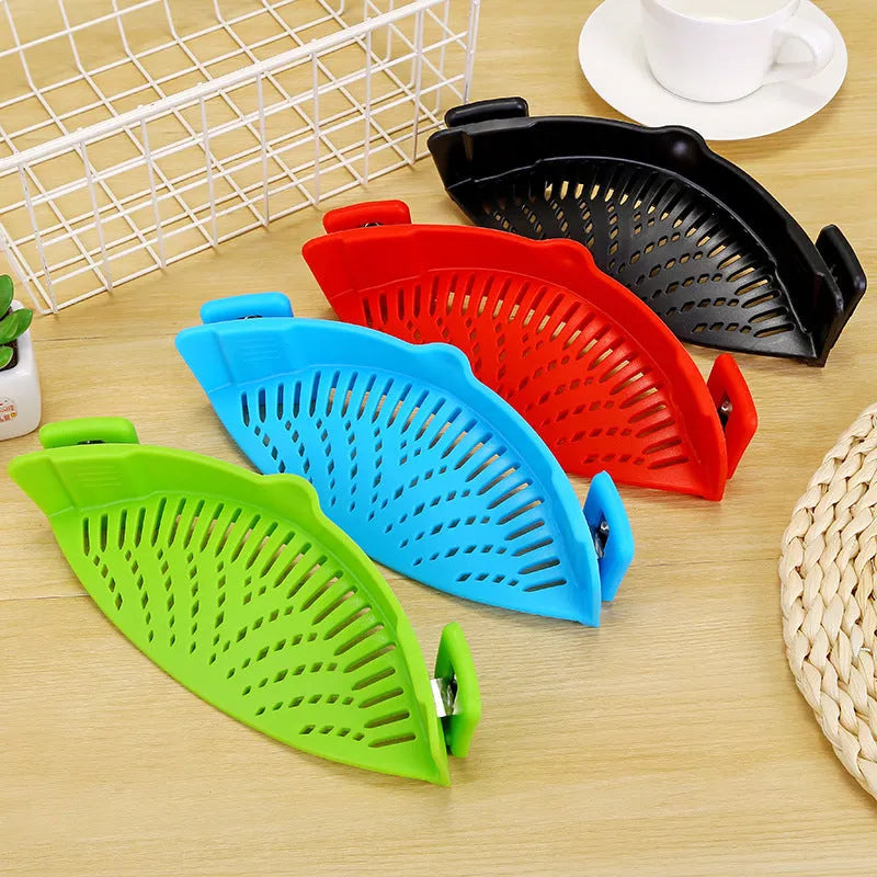 Silicone clip-on funnel strainer attached to kitchen pot for draining liquids