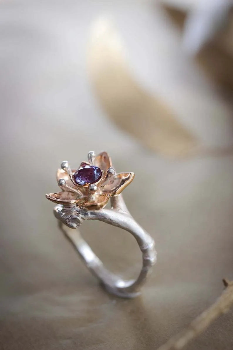 Silver two-tone women's ring with geometric floral design showing alloy construction and size options
