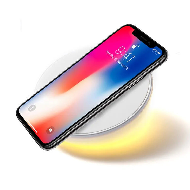 White wireless charging pad with digital clock display and control buttons