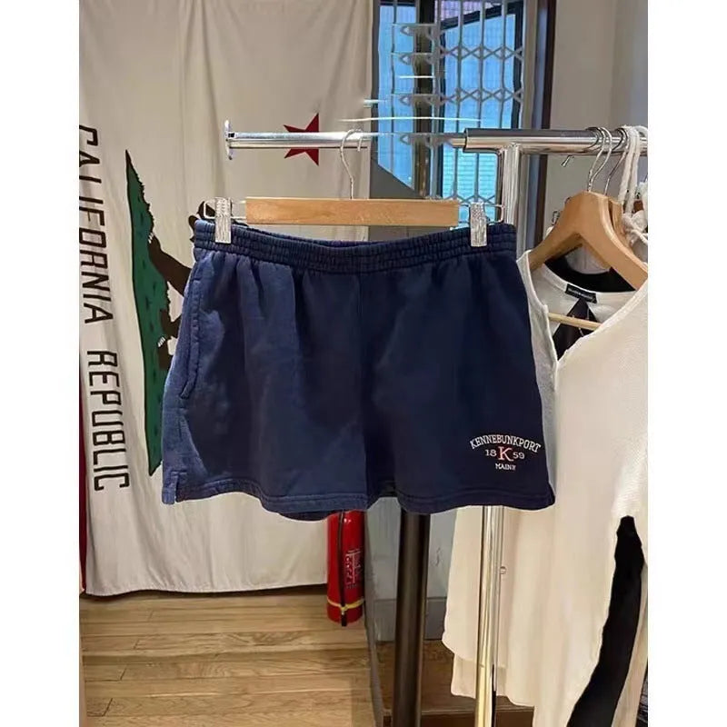 Dark blue cotton athletic hot pants with white flag embroidery and navy blue panels