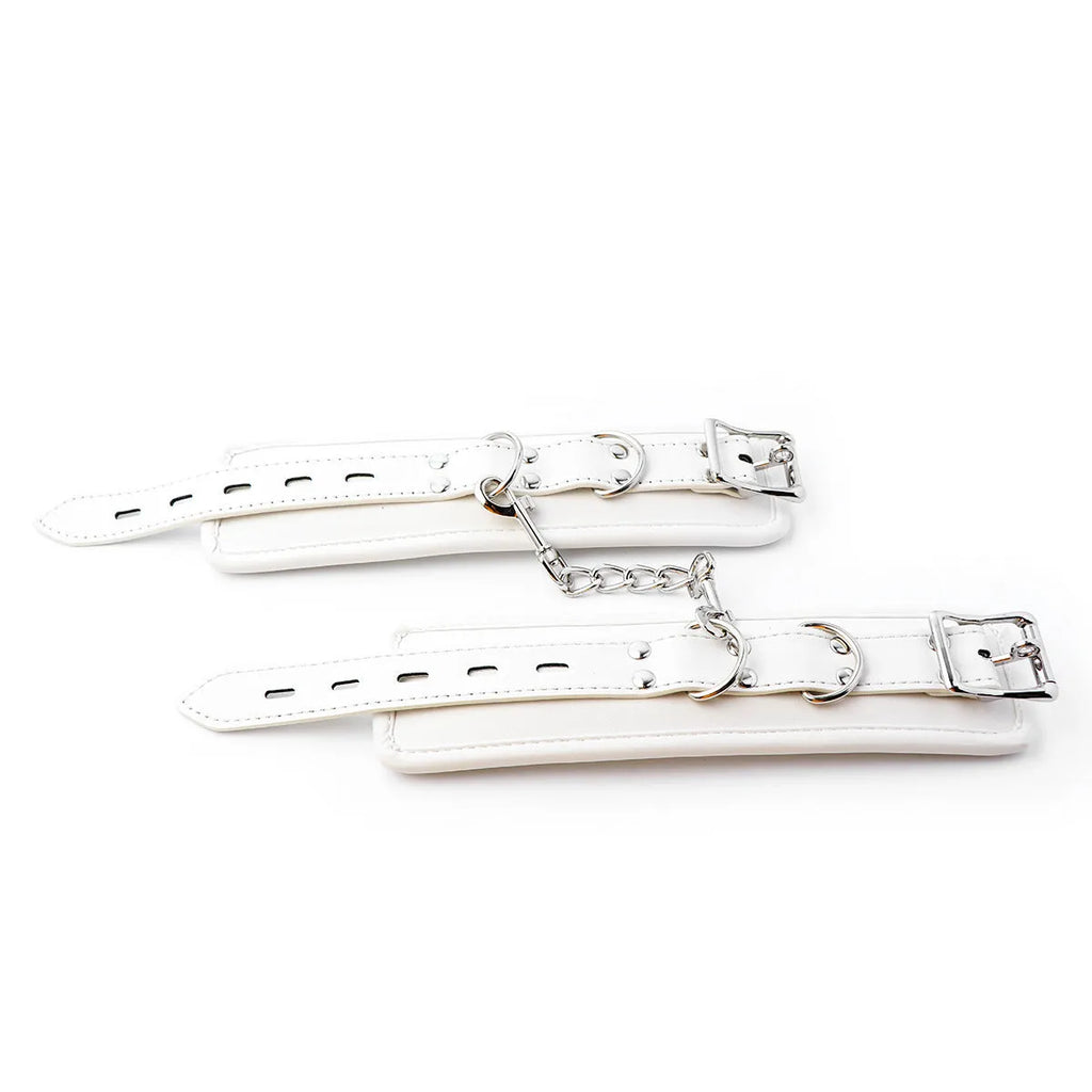 White PU sponge bondage set showing handcuffs, ankle cuffs, and a neck restraint collar.