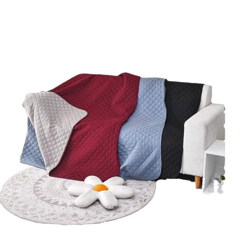Reversible waterproof dog blanket sofa cover in burgundy and grey, laid flat on a sofa.