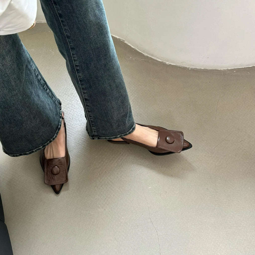 Women's low heel pointed toe sandals with a back strap in black, shown from the side.