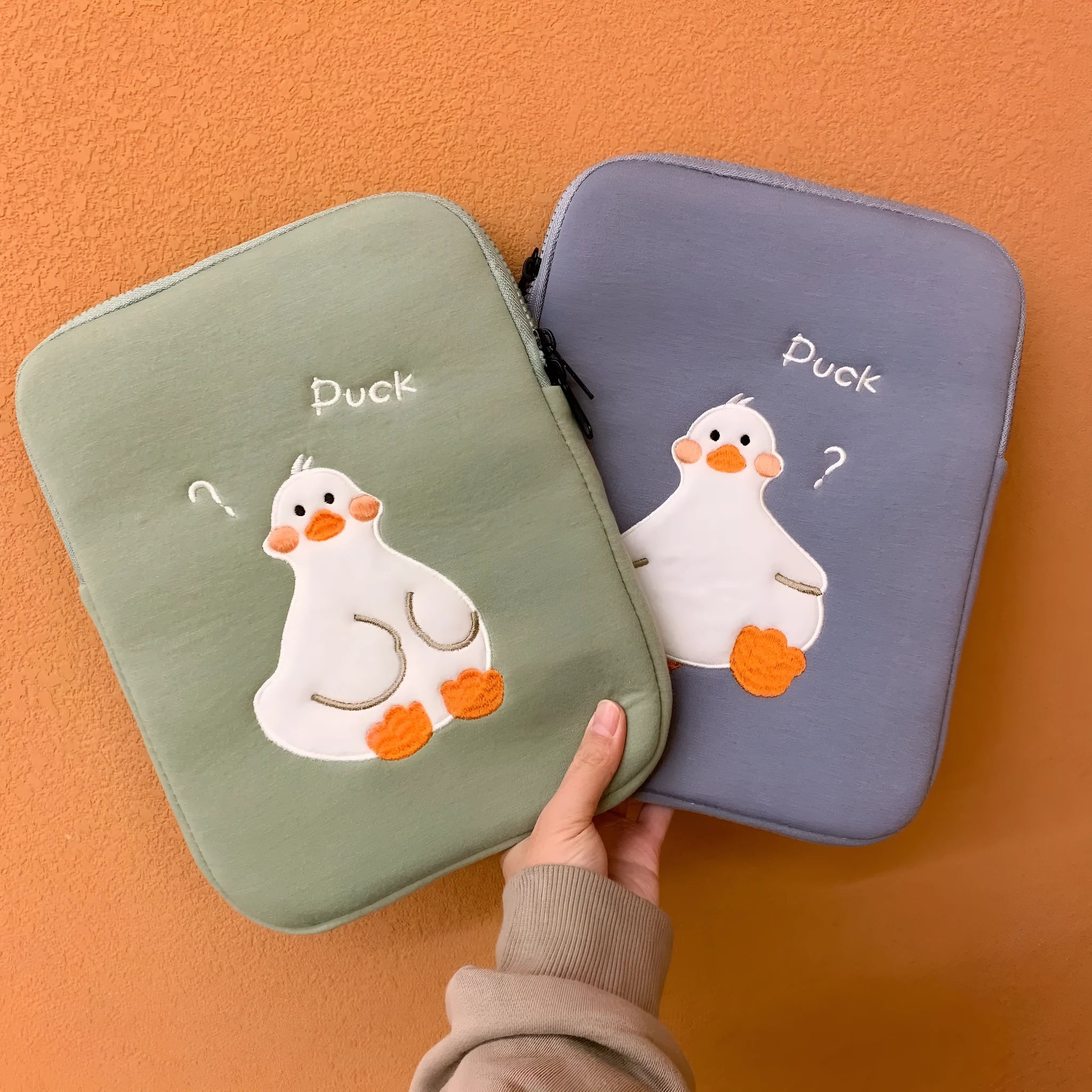 Blue cotton tablet case with embroidered duck design and zipper closure