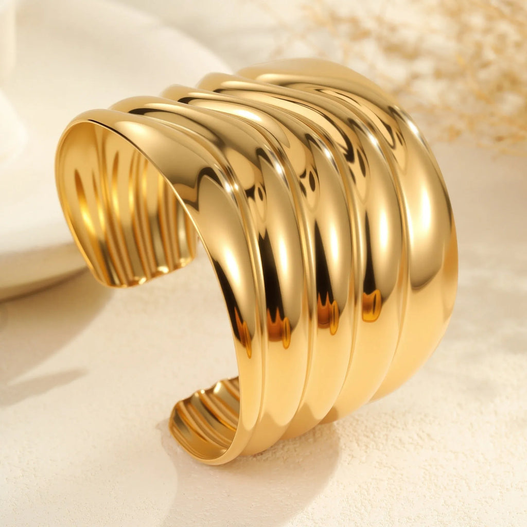 Gold plated stainless steel bracelet with exaggerated wide geometric wave design and asymmetric opening