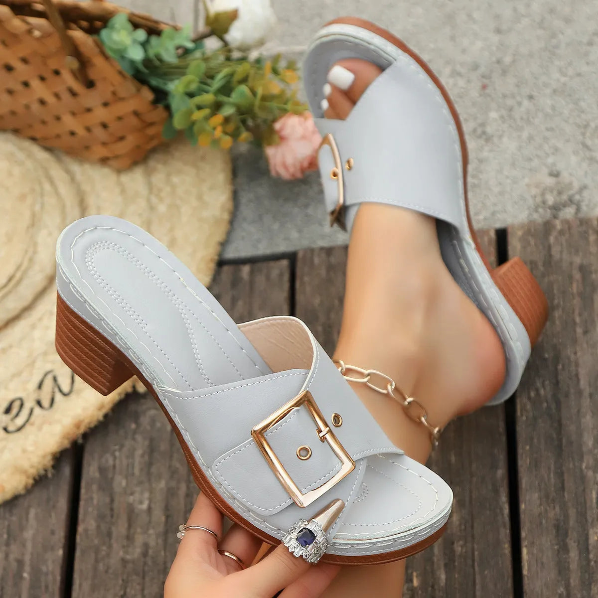 Women's black chunky heel beach slippers with metal buckle detail on round toe design