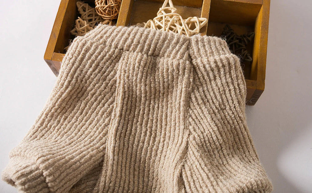 Brown cloth dog sweater pullover on a small white dog, showing casual style.