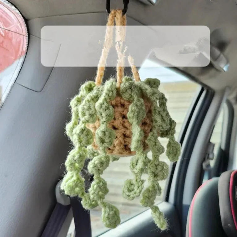 Green and white knitted wool car plant decoration with plastic base and hanging rope