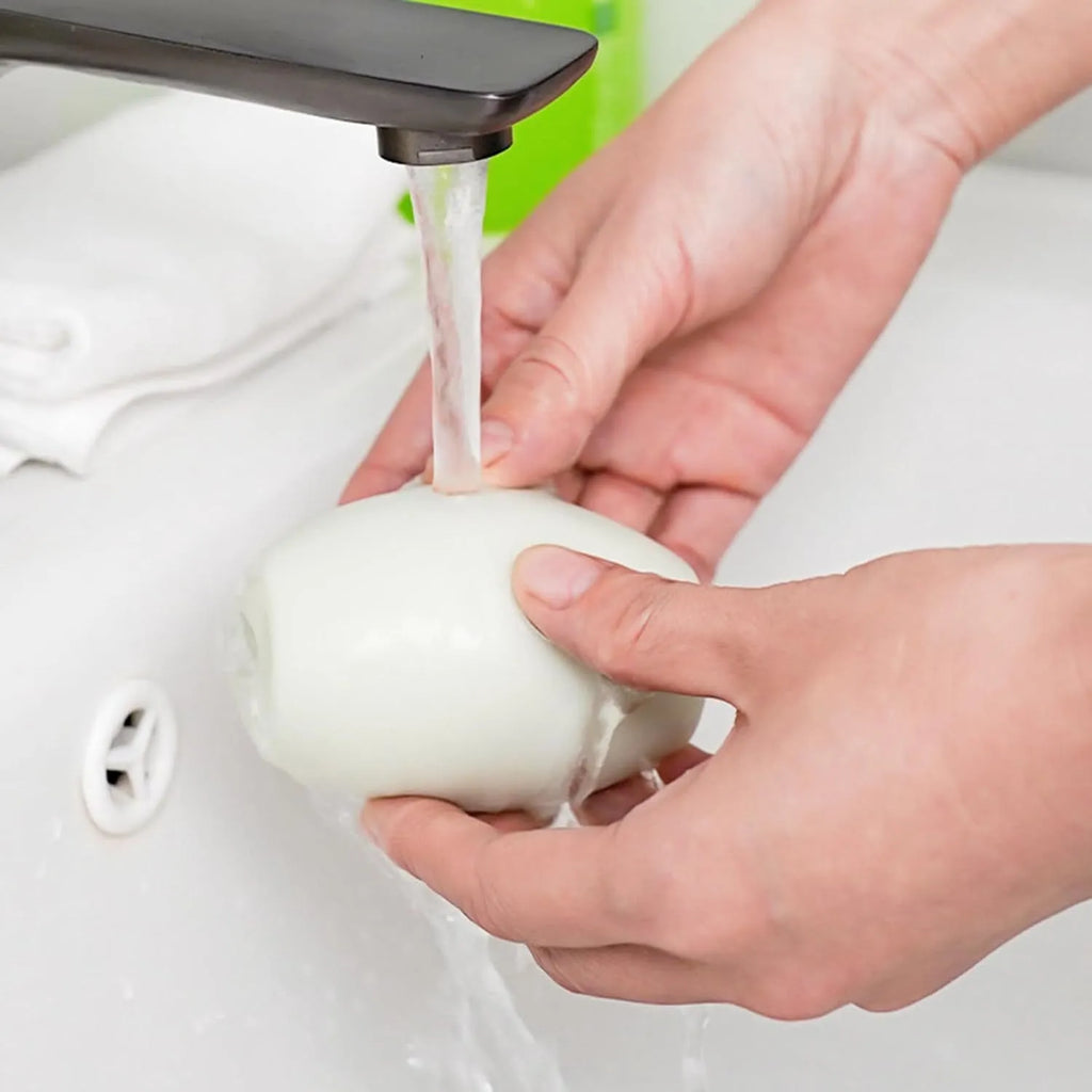 Green reusable gel lint roller ball for pet hair removal from clothes and furniture