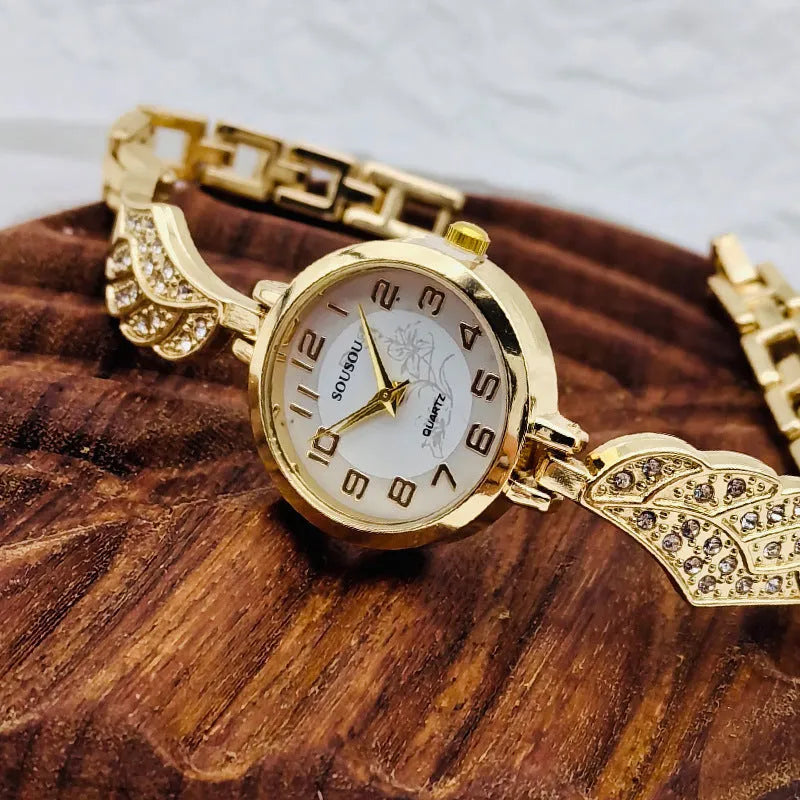 Stainless steel women's watch with round dial and Vachette clasp buckle on wrist.