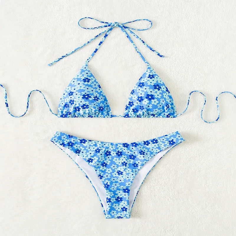 Women's blue floral print two-piece swimsuit with lace-up front and side-split shorts