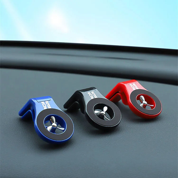 Magnetic car phone holder mounted on vehicle air vent with smartphone attached showing adjustable rotation mechanism