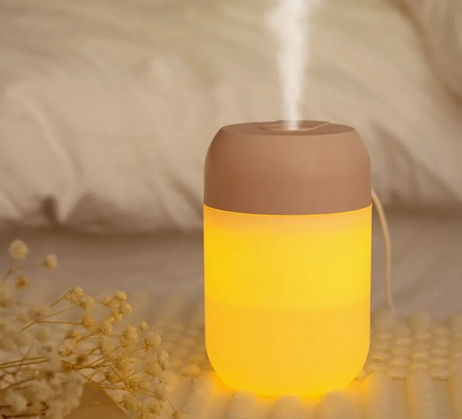 Small white cylindrical USB-powered humidifier on a desk