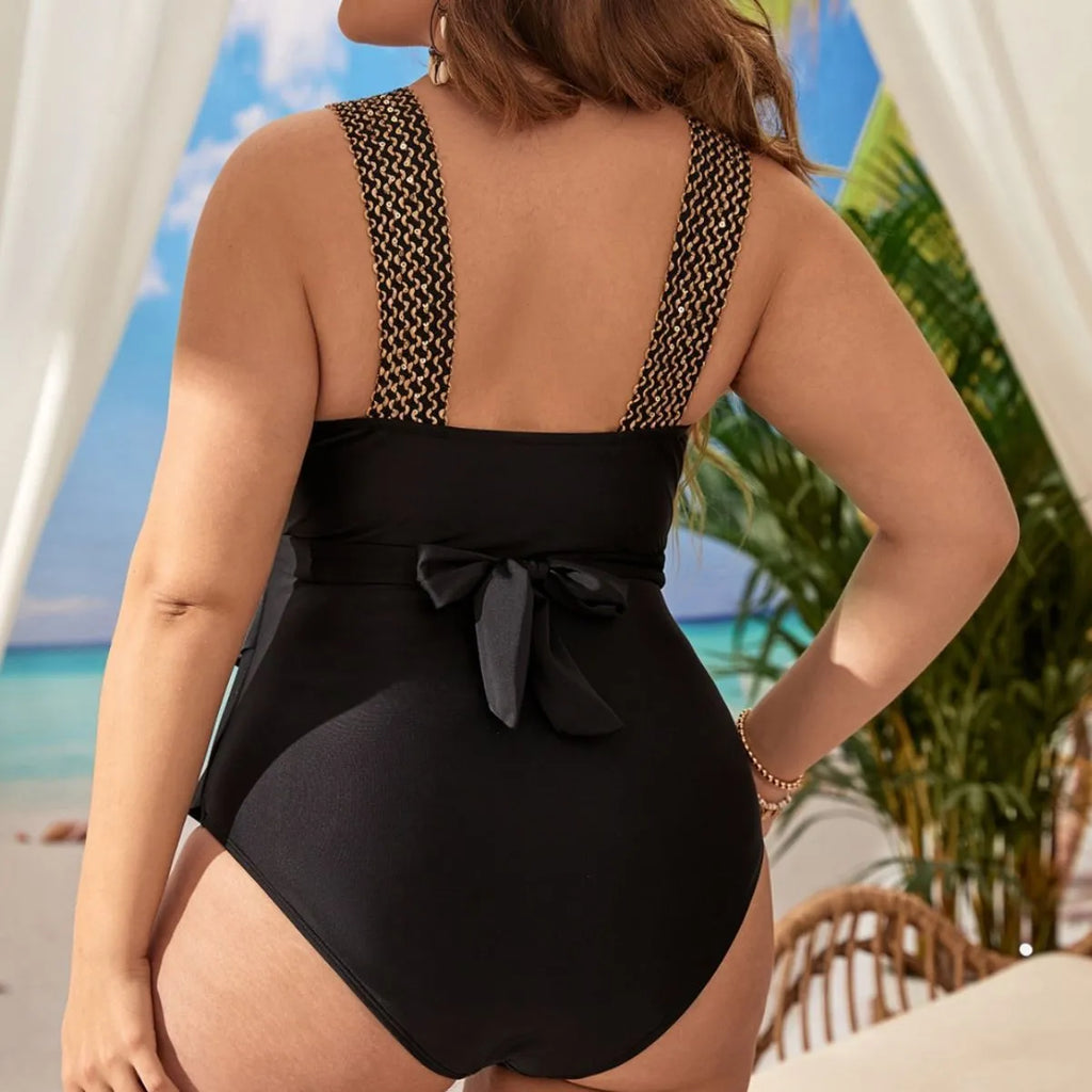 Women's black one-piece swimsuit with chest pads, sleeveless design, for swimming and fitness.