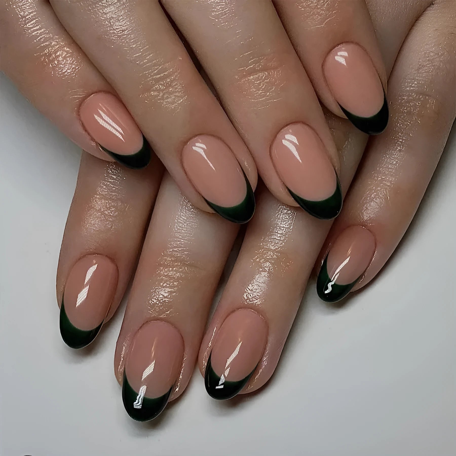 24 piece set of short almond shaped false nails with a simple black French style design.