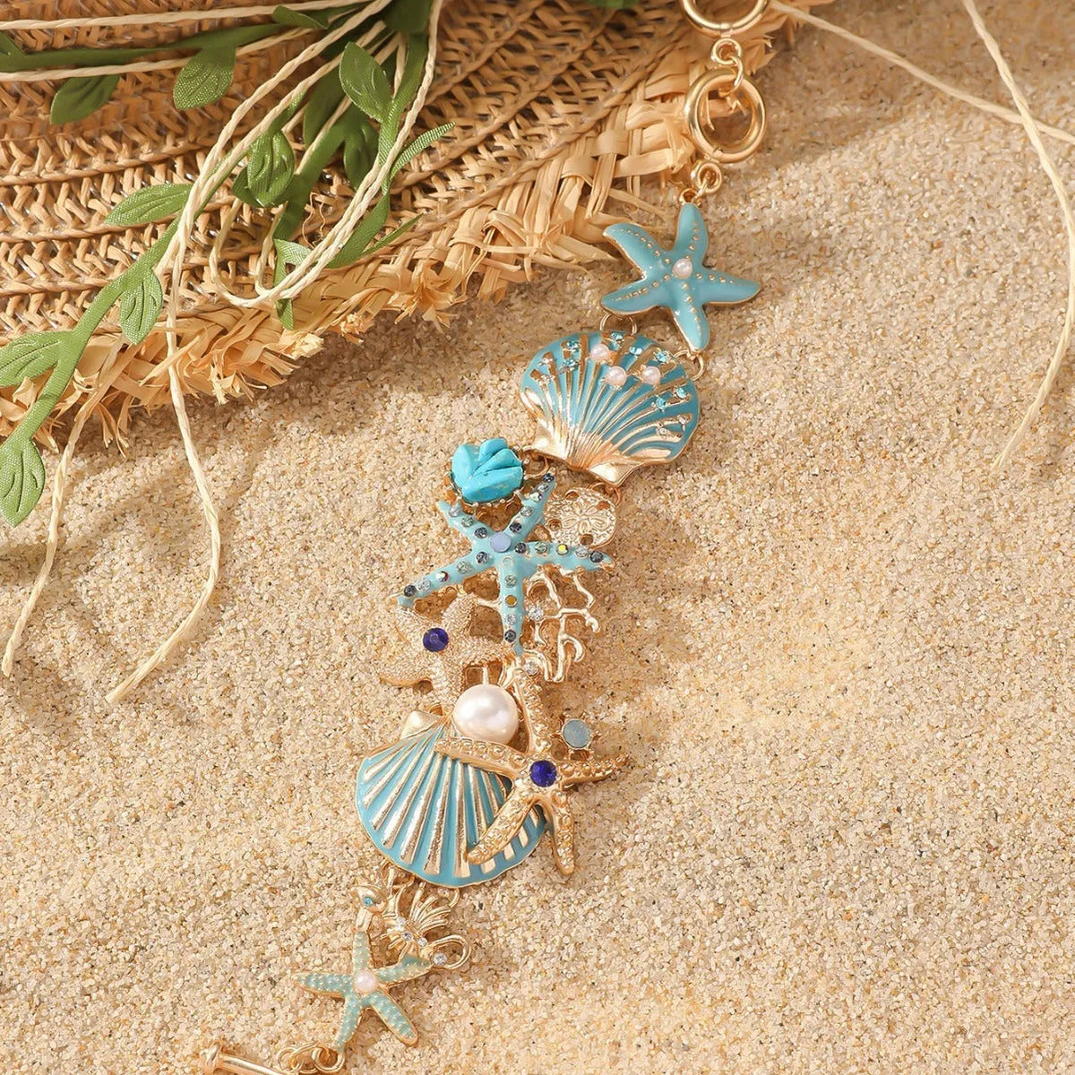 Women's alloy marine bracelet with boat anchor and starfish charms in turquoise, red, or blue coral colours.