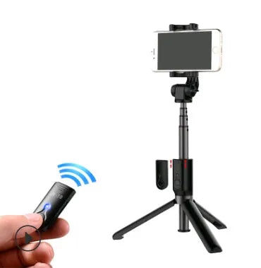 Bluetooth selfie stick tripod with remote control extended with smartphone attached