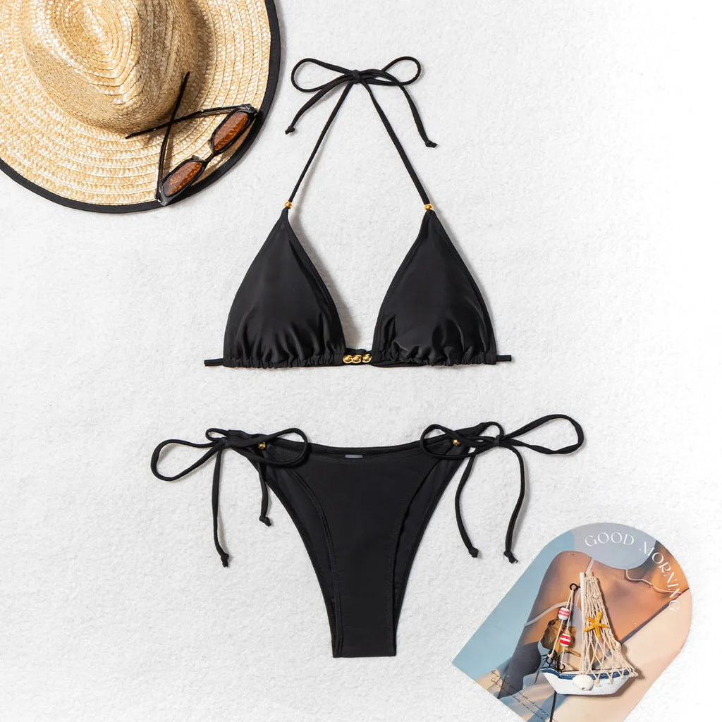 Black women's bikini swimsuit with metal bead detail on a split style design