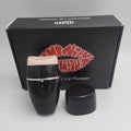 Black and white electric lip plumper device with silicone tip and 3 speed buttons
