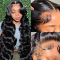 Black synthetic full-head wig with medium-long curly waves, shown on a model or wig stand.