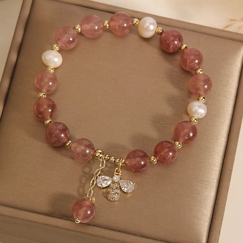 Women's bracelet with freshwater pearls and strawberry quartz stones with zircon accents on alloy hardware