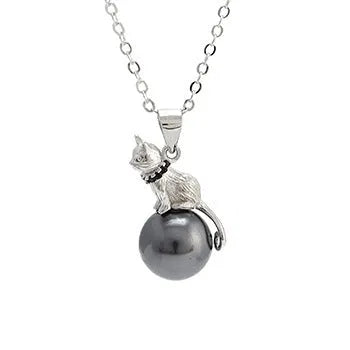 Close-up of a sterling silver cat pendant necklace on a clavicle chain.