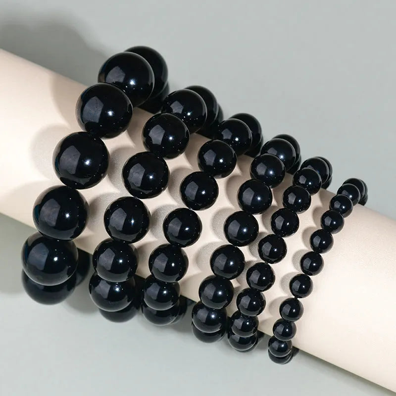 Hand-woven obsidian crystal bracelet couple set showing six colour variations with round beads