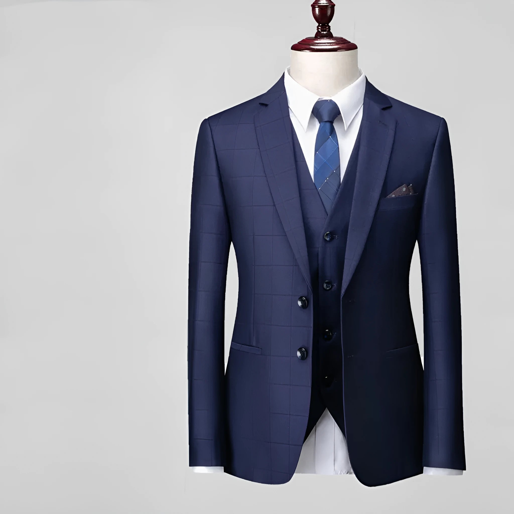 Men's navy blue slim fit plaid three-piece suit with jacket, vest, and trousers on a hanger.