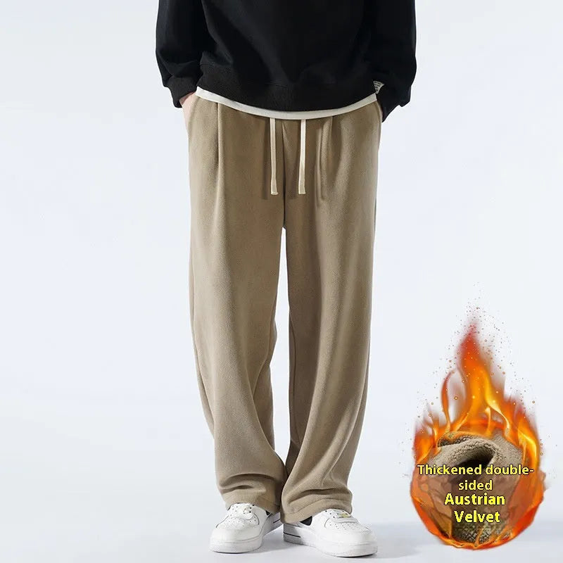Man wearing loose apricot fleece-lined sports trousers with a drawstring waistband.