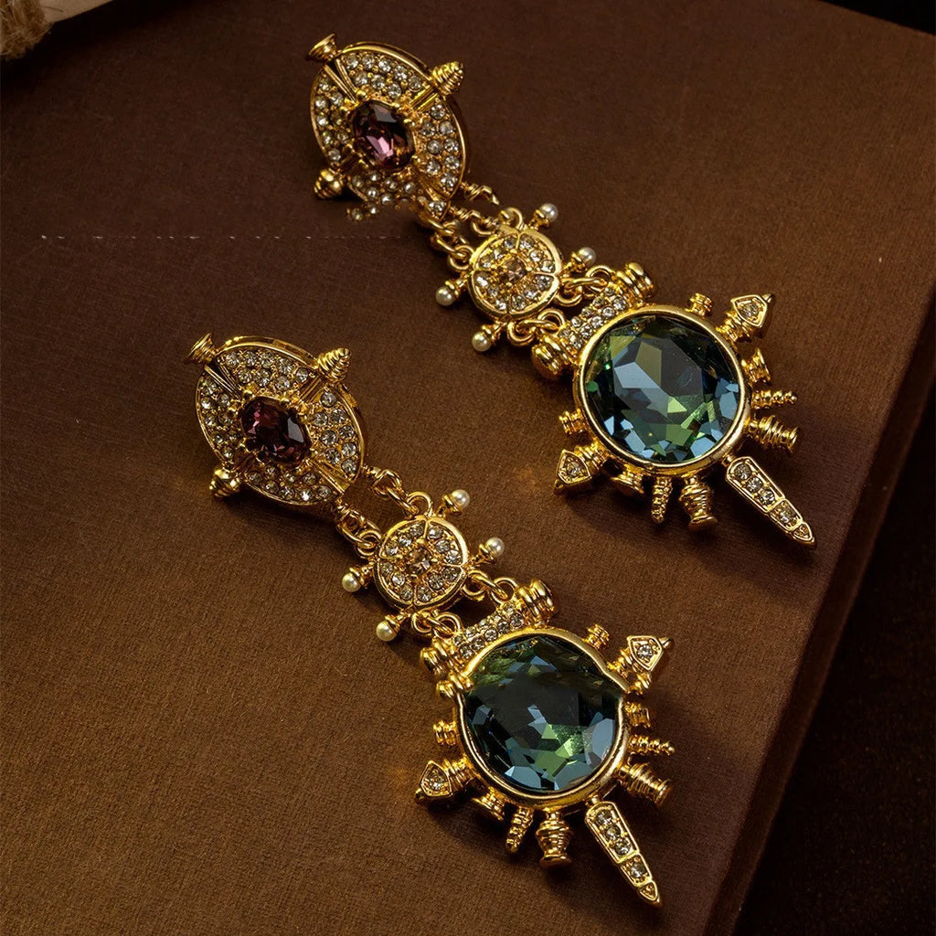 A pair of gold-coloured geometric round stud earrings with a retro style and diamond-treated alloy finish.