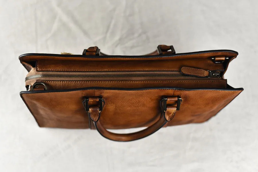 Men's horizontal leather handbag in black or khaki with zipper closure and 14 inch width
