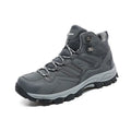 High-top hiking sneakers in multiple colours with flannel uppers and rubber soles on a rocky path.
