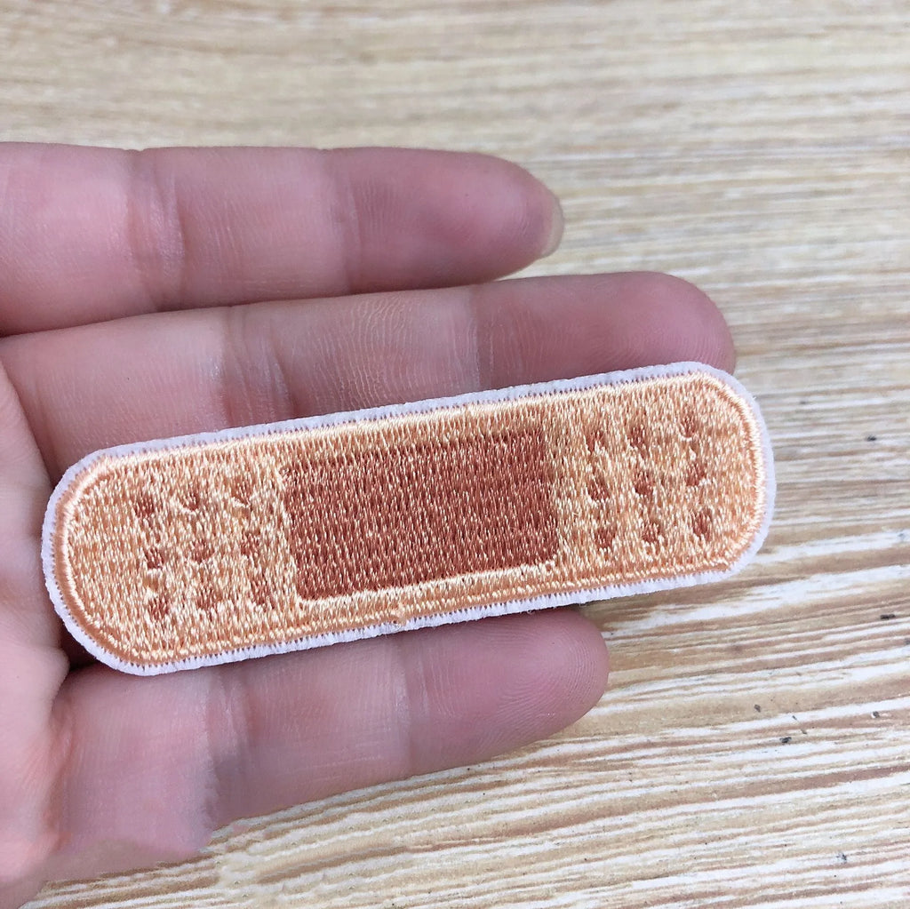 Pack of 10 colourful embroidered iron-on patches for clothing decoration.