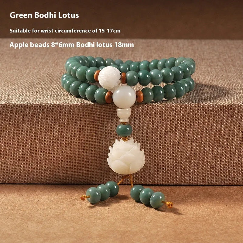 White and green beaded bracelet with a double ring safety buckle and a prominent double ring lotus bead decoration.