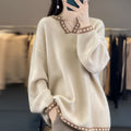 Women's camel coloured V-neck pullover sweater with long sleeves on a hanger.