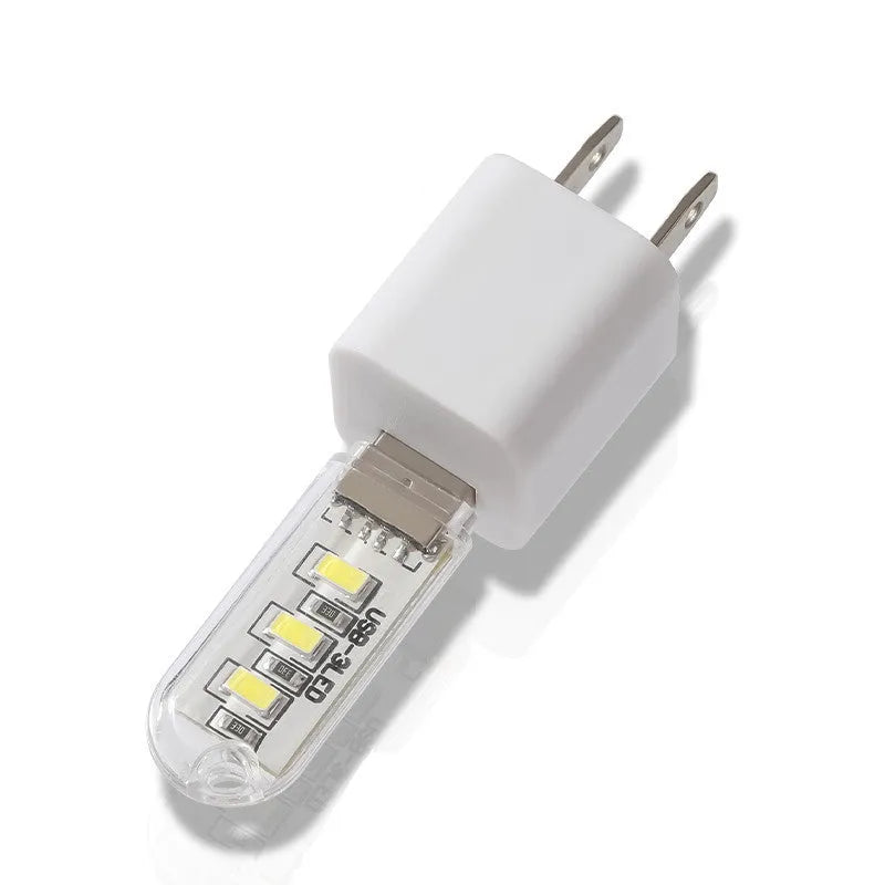 Small white LED night light showing warm and cool light options with USB charging port