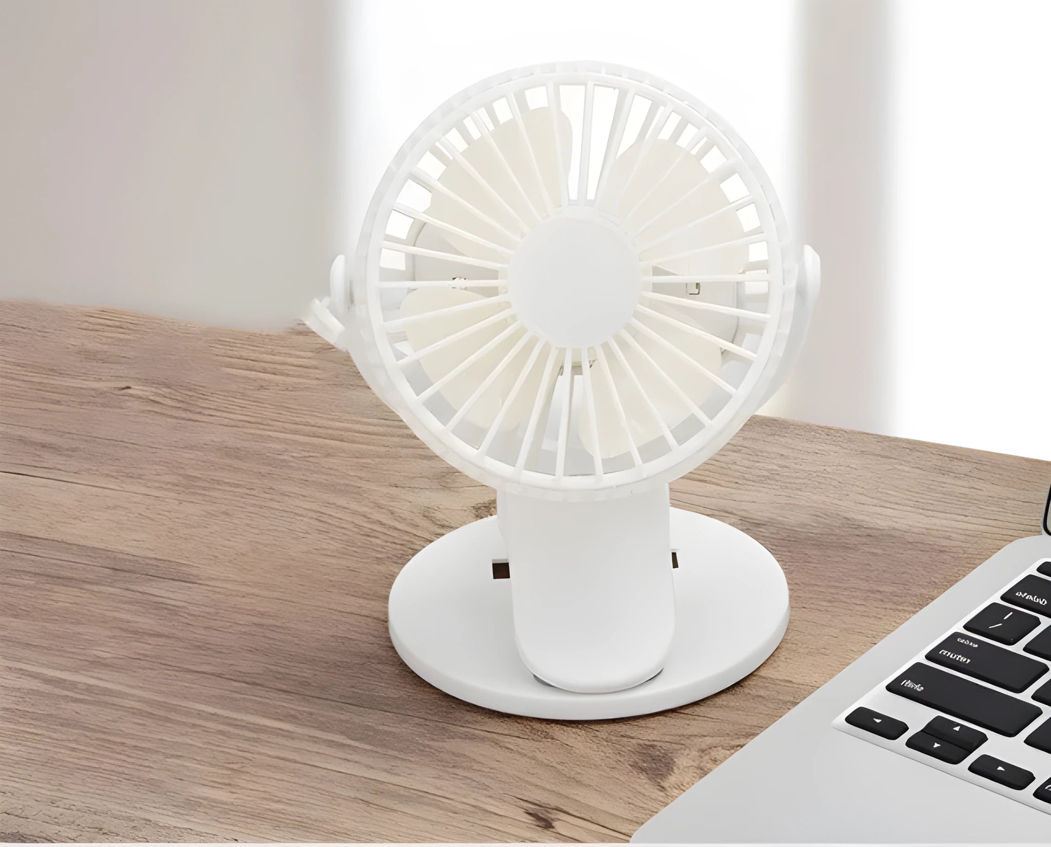 White USB rechargeable clip-on desk fan with plastic blades and a black clip attached to a surface.