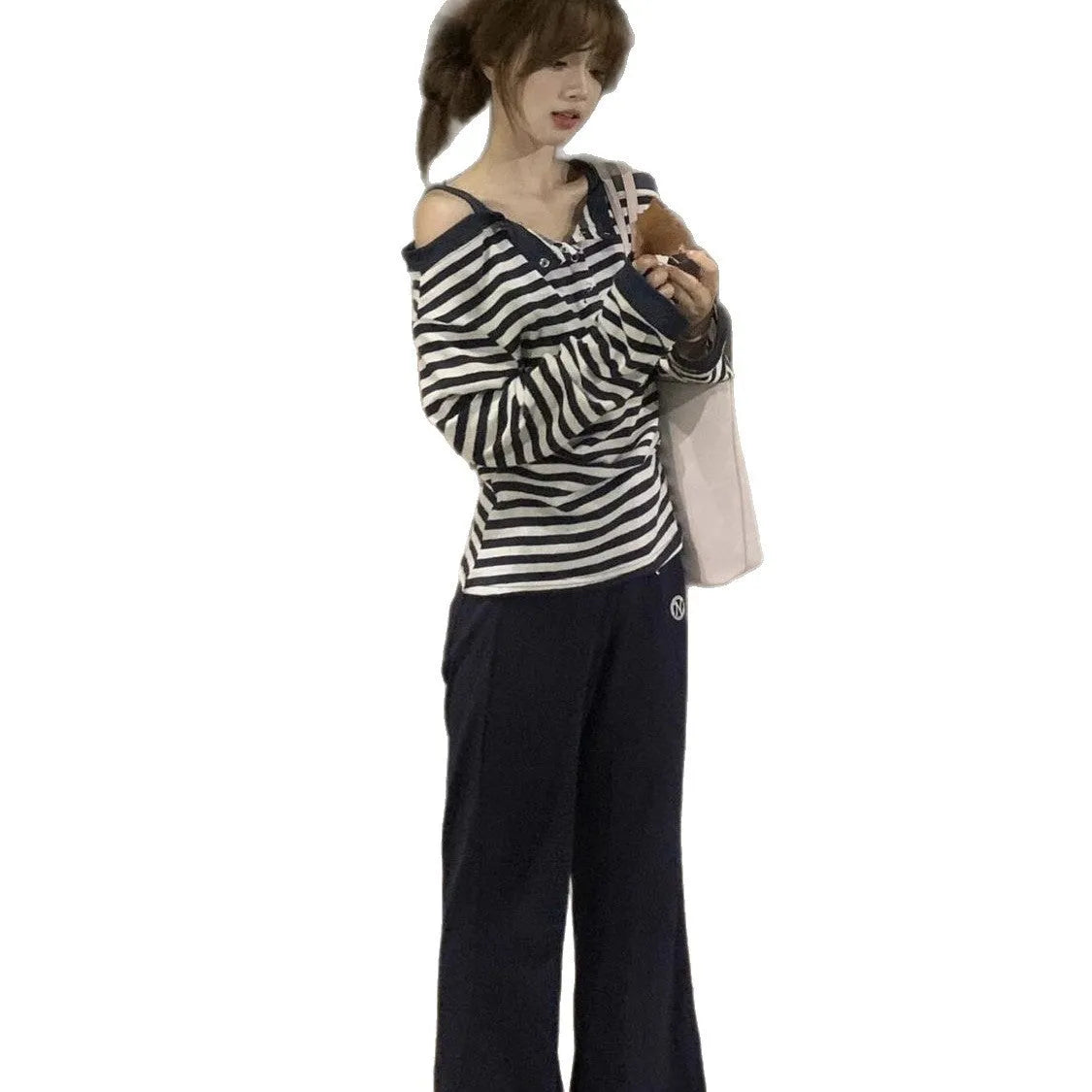 Dark blue oversized women's long-sleeved t-shirt with stripes and embroidery on a hanger.