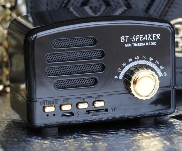 Vintage wood Bluetooth speaker in black, pink and wood grain colours showing compact design