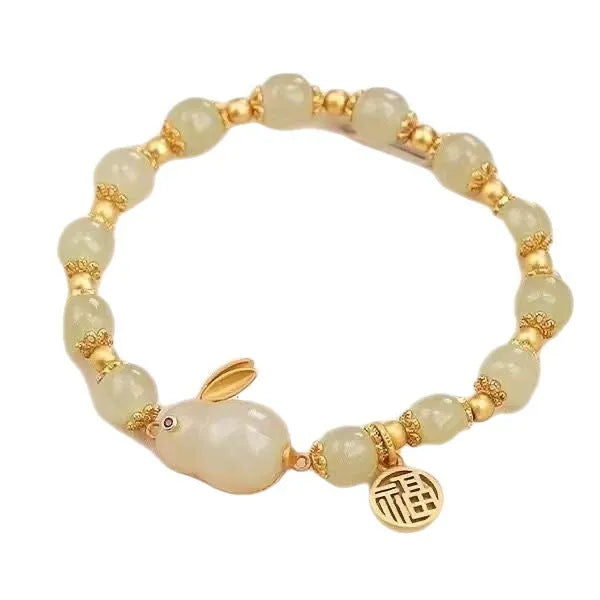 Women's black adjustable bracelet with green jade fu character, jade hare charm, and Lily decorations.