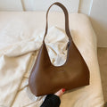Retro style PU shoulder handbag in pillow shape with single strap and internal organisation pockets