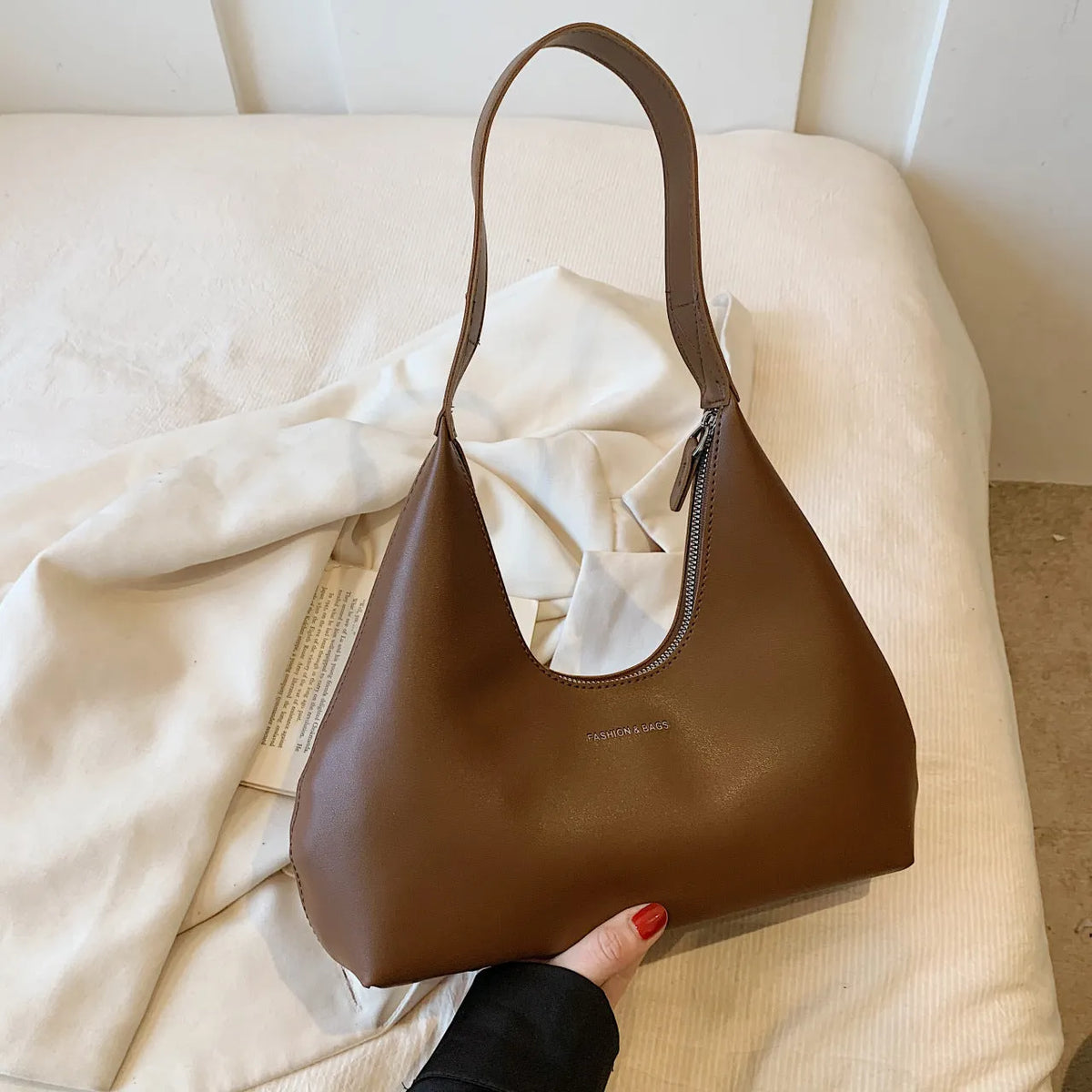 Retro style PU shoulder handbag in pillow shape with single strap and internal organisation pockets