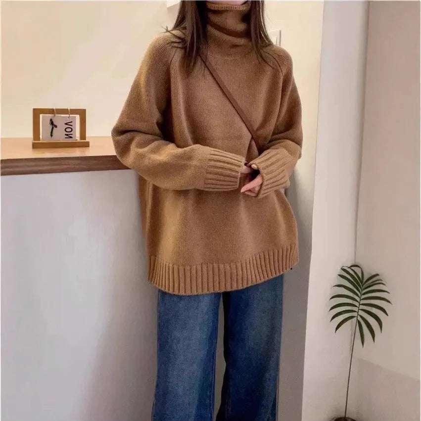 A woman's loose-fitting thick turtleneck sweater in a solid colour with a 3D textured pattern.