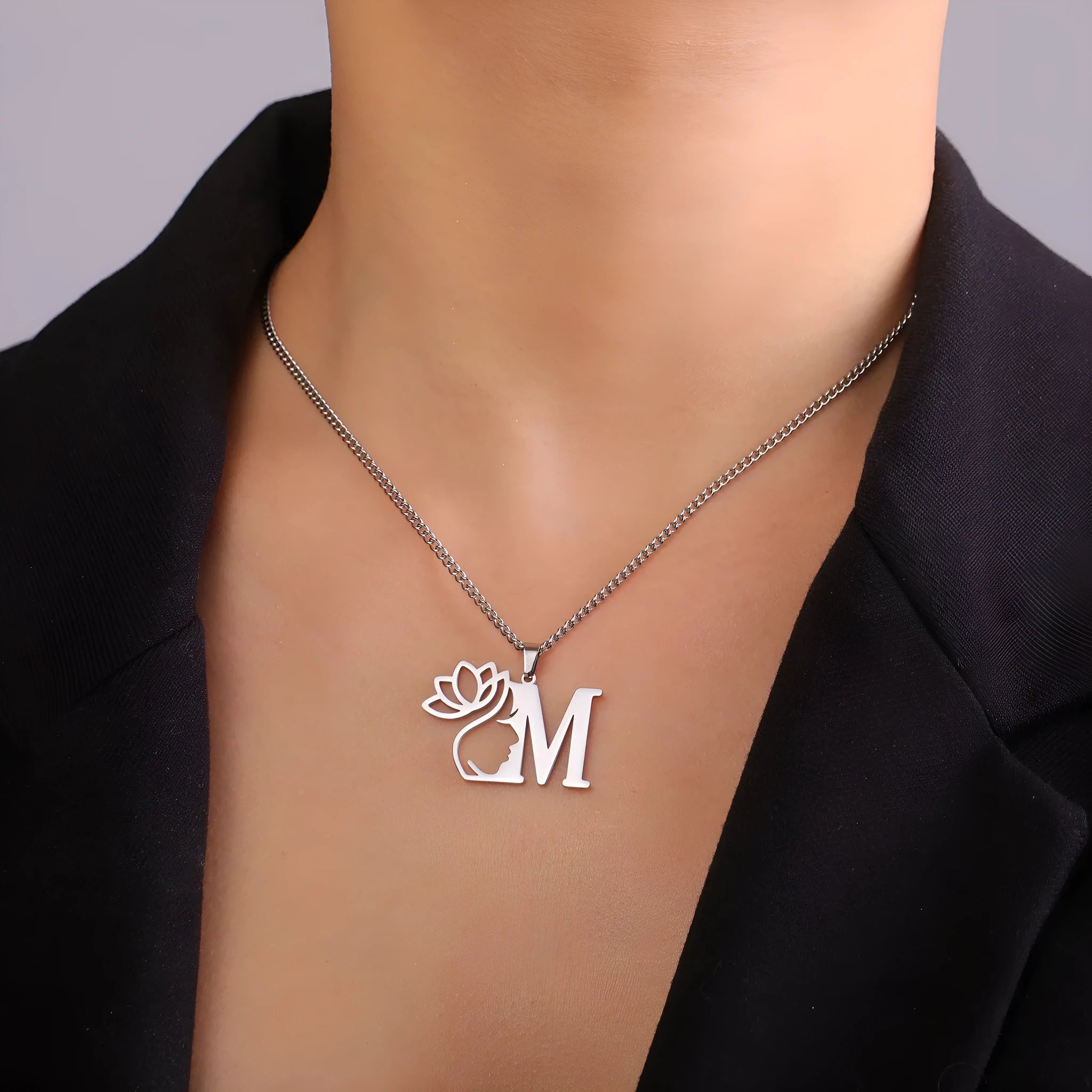 Women's stainless steel necklace with single pendant in gold or silver electroplated finish on a cross chain.