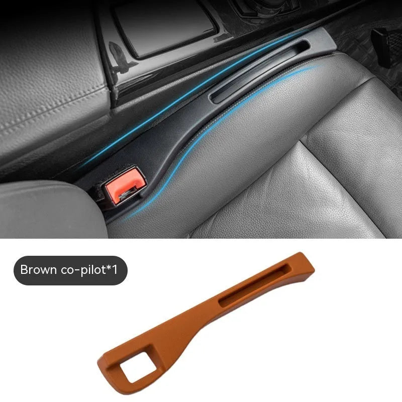 Black plastic car seat gap storage pocket with handle placed between vehicle seats.