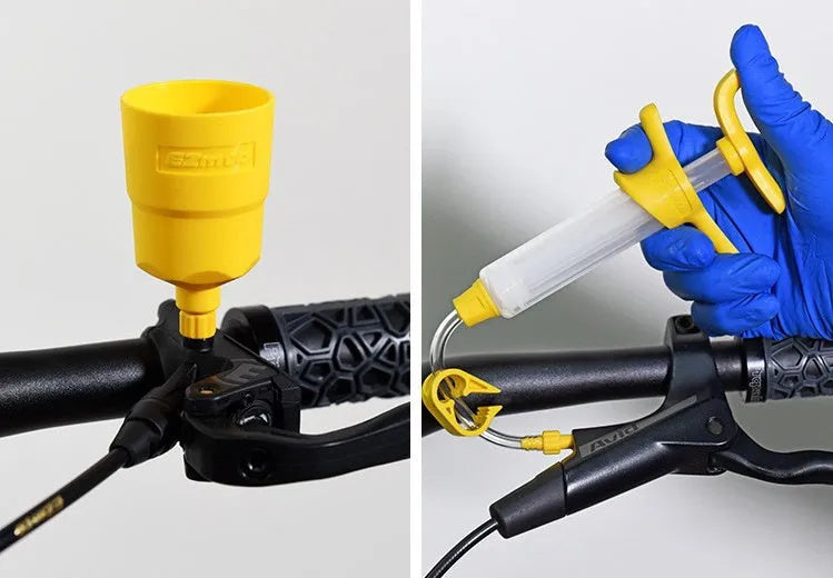 EZmtb bicycle hydraulic disc brake bleed kit with syringes, adapters, and tools on a workbench