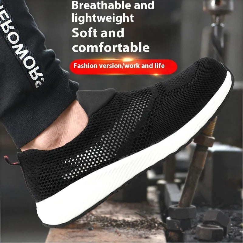 Men's black lightweight steel toe safety work shoes with mesh upper on a workbench