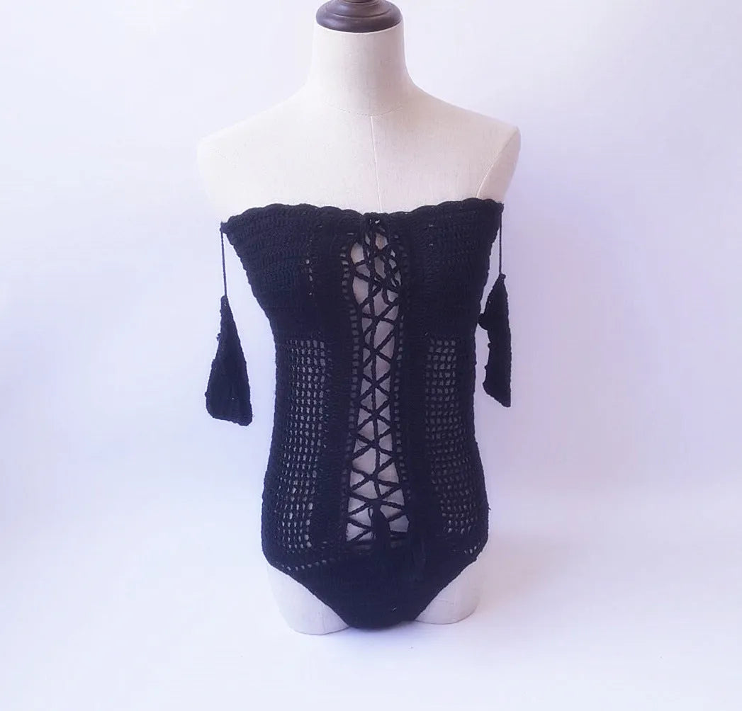 Women's off-shoulder one-piece swimsuit in light pink on a mannequin.